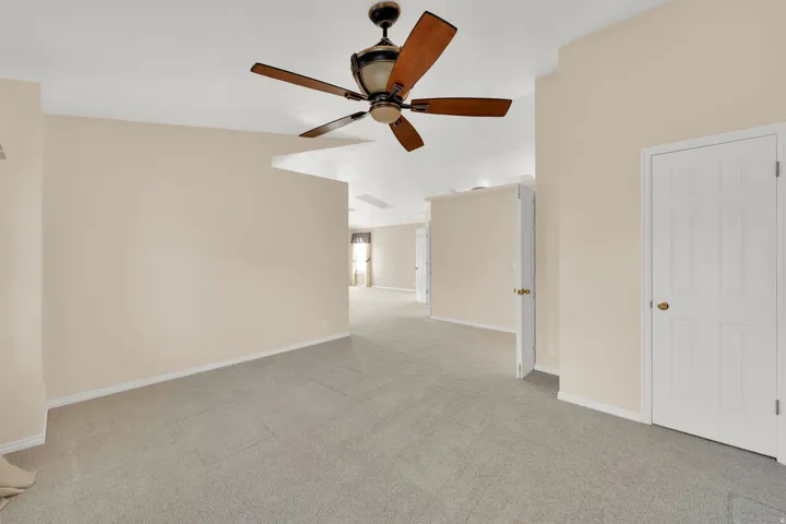 Spacious interior featuring neutral carpet flooring and light beige wall paint