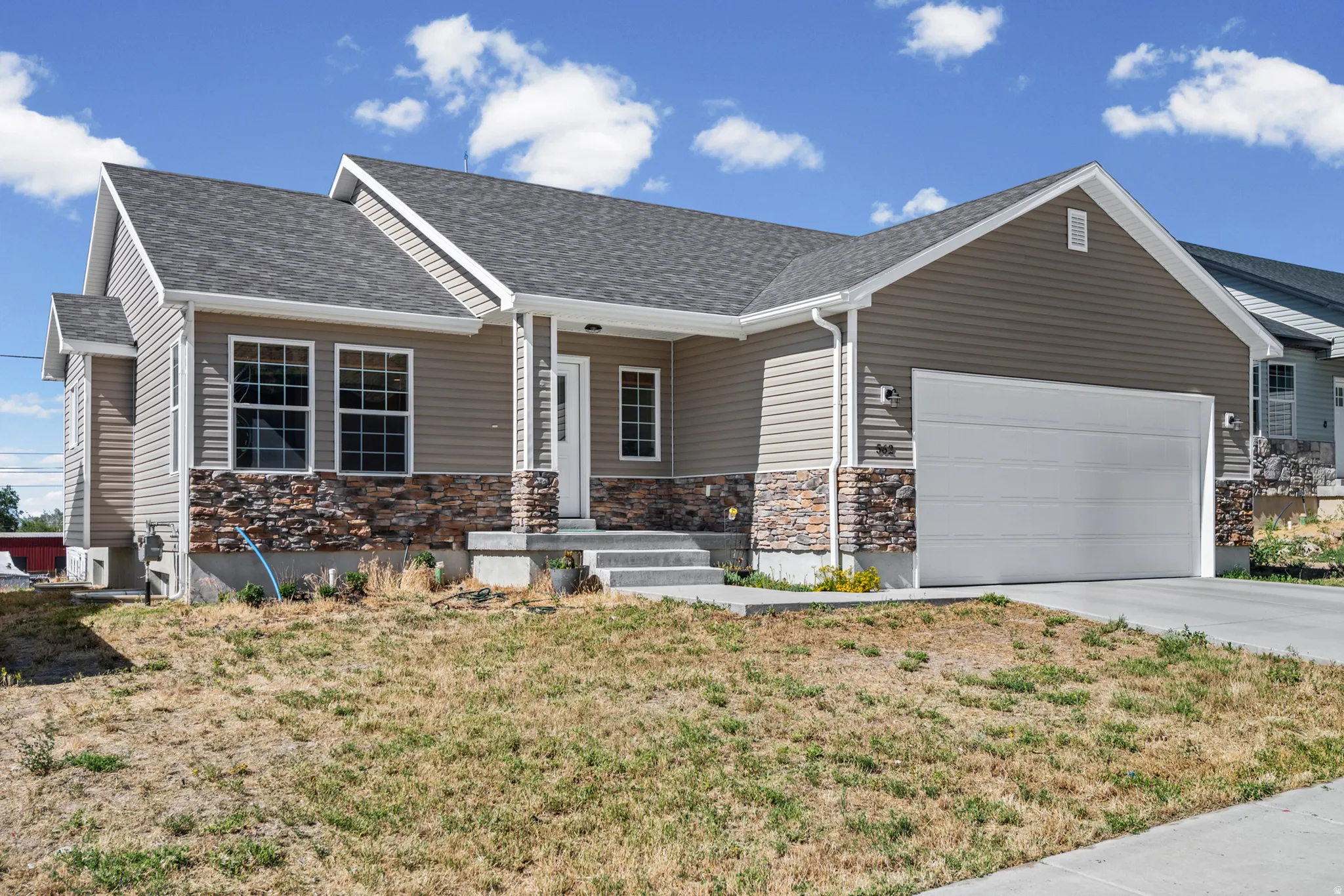 Contemporary ranch-style residence featuring a prominent two-car garage