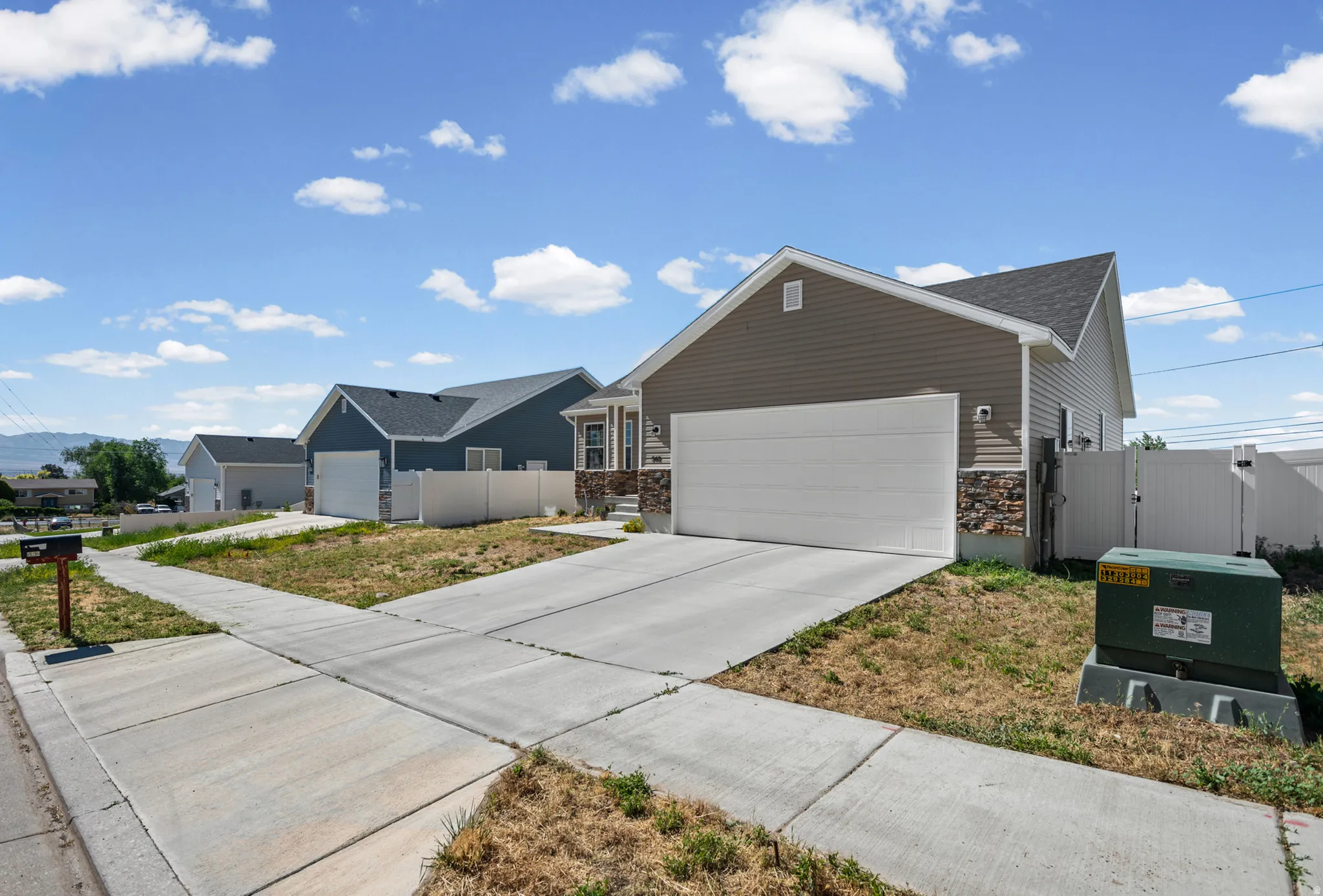 Modern siding exterior with stone accents and an attached garage