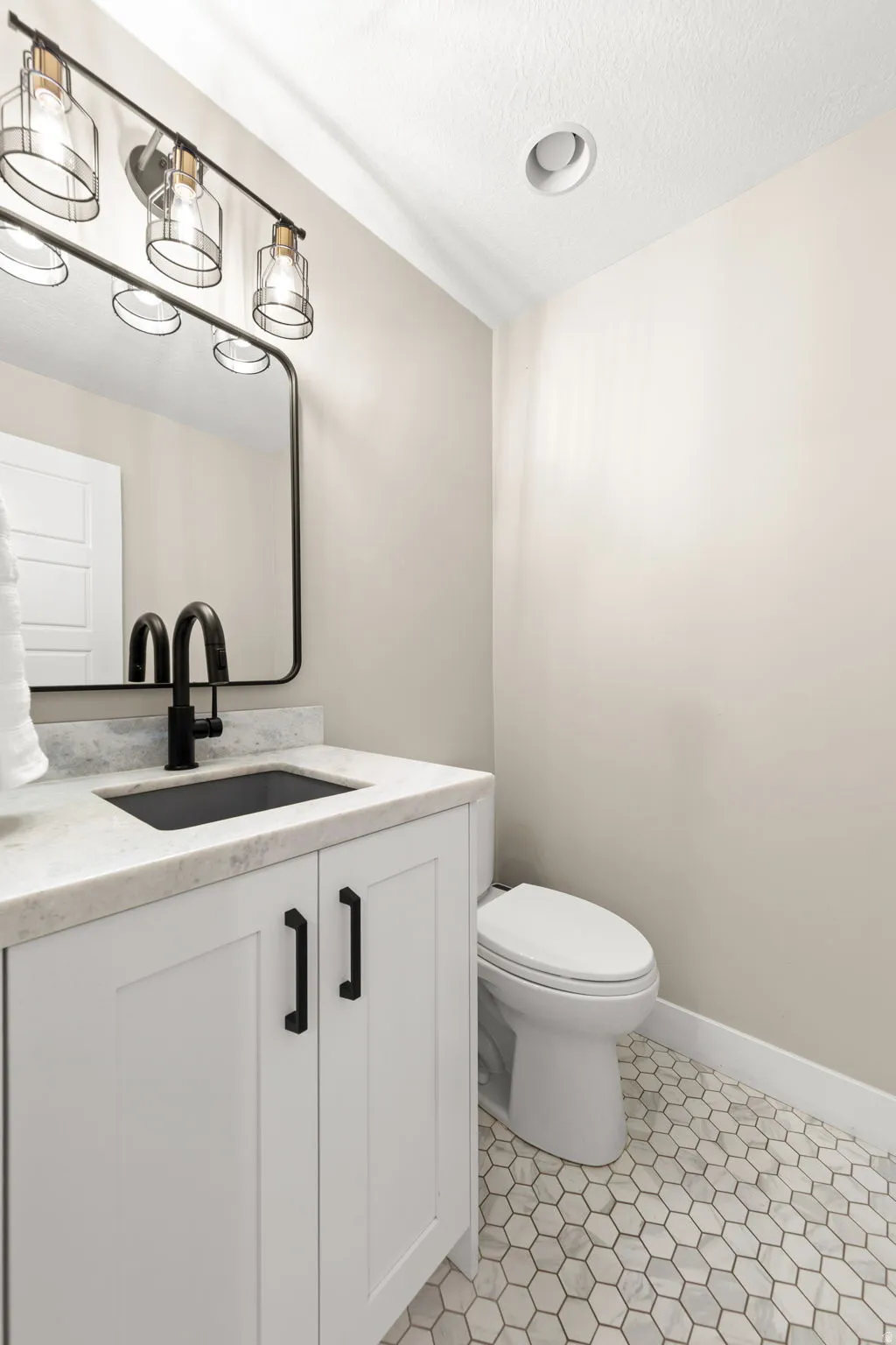 New Bathroom just inside garage entrance by Mud Room.  Deep Granite Deposit Sink with matching faucet!