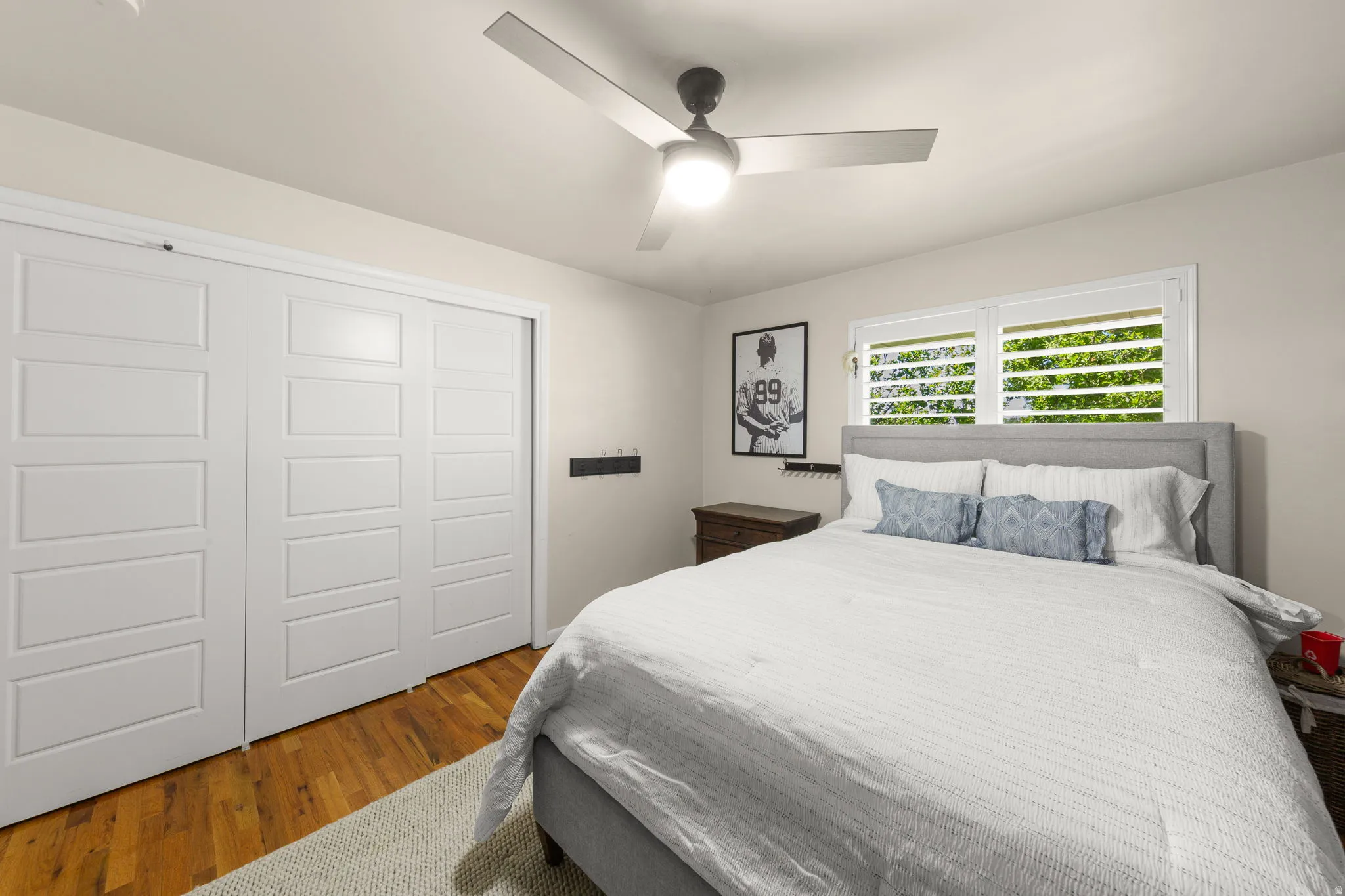 Large Bedroom 3 showing a King Bed, Plantation Shutters, Oak Hardwood Floors and large closet with sliding doors.