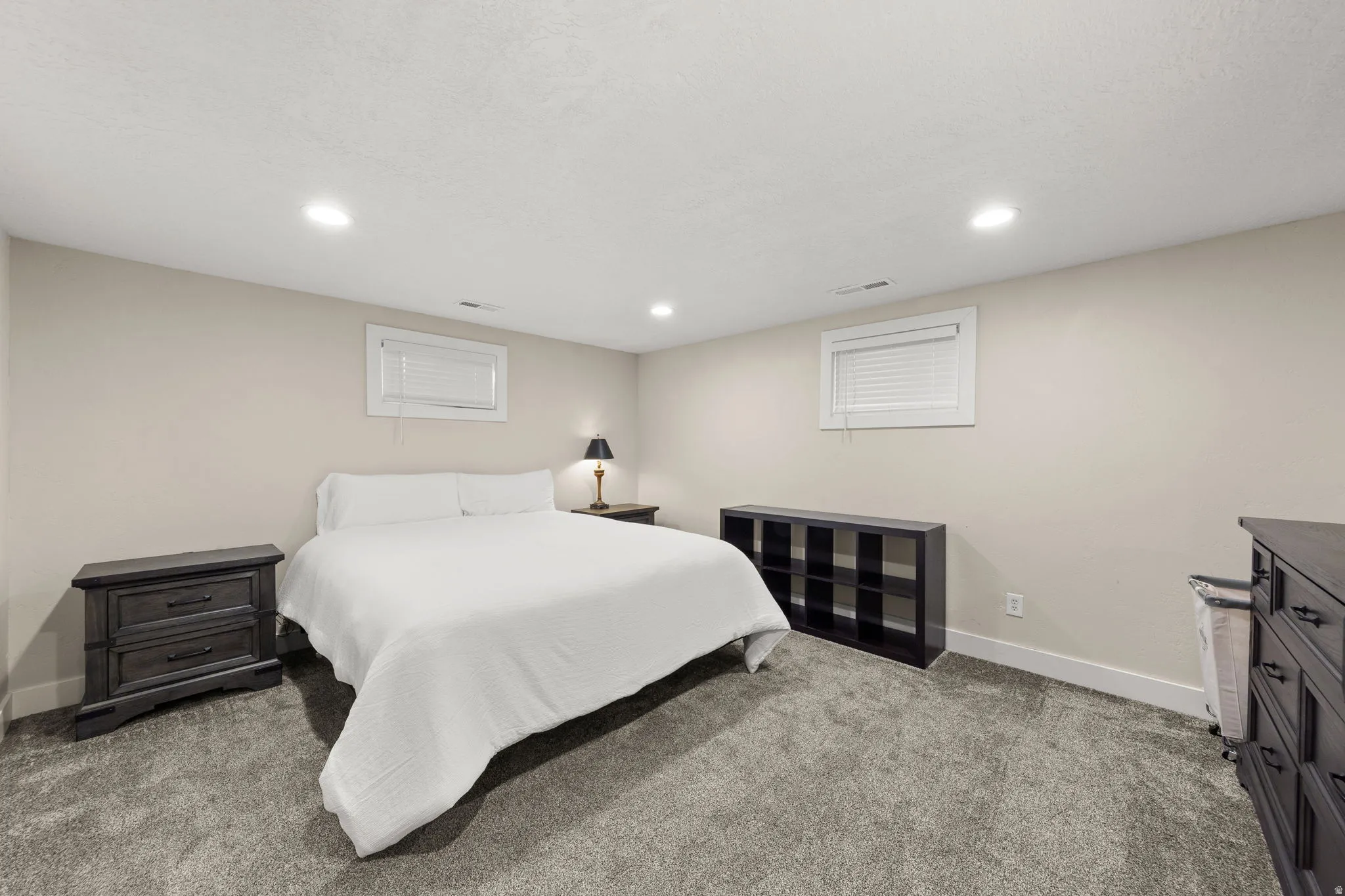 Remodeled Large Bedroom in Mother in Law Apartment showing a California King Bed.  With Blinds & Lots of Canned Lighting!