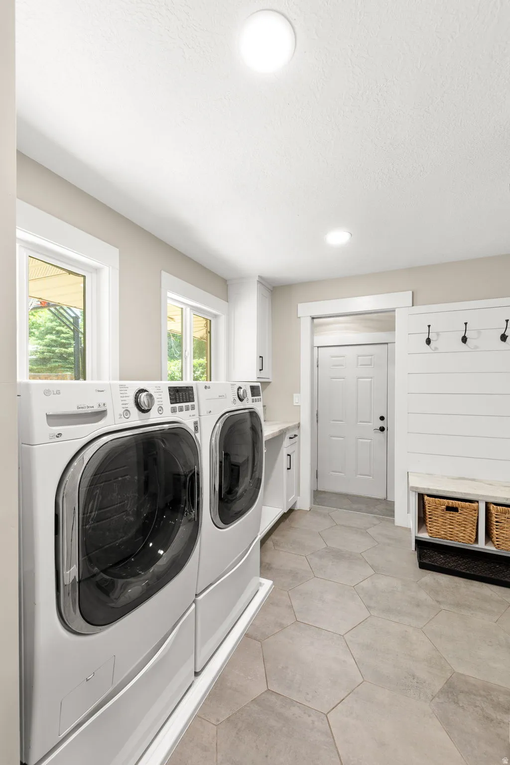 Large Light Laundry Area!  Lots of Natural Light!  Windows span across front and back of house!