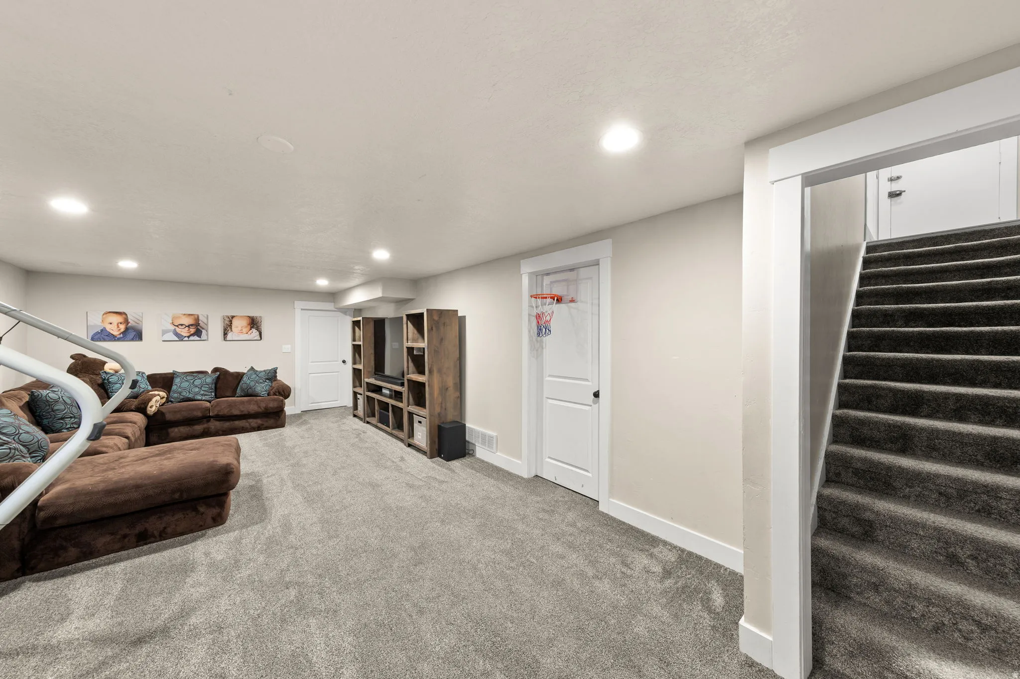 Large Family Room, Recessed Lighting,  Door to Large Storage Area.