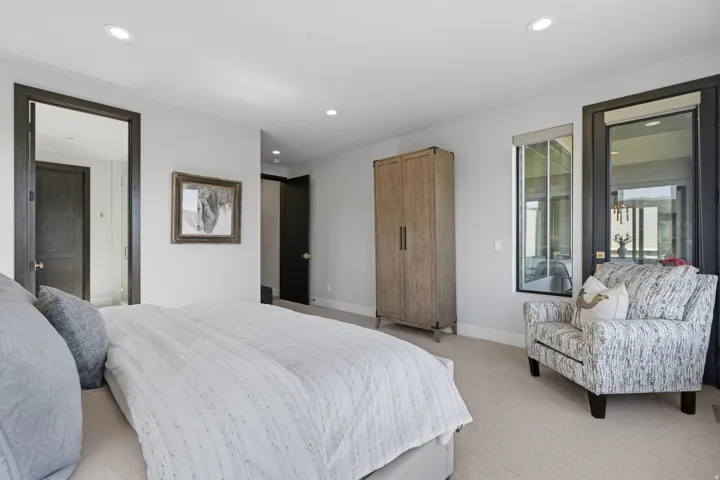 Carpeted room featuring recessed lighting and dark-framed windows