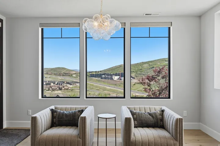 Three large windows frame a distant mountain landscape