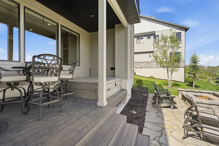 Outdoor living area featuring a multi-level deck and stone patio
