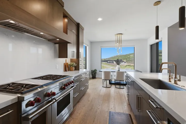 Gourmet kitchen featuring a professional-grade range, integrated vent hood, and abundant cabinetry