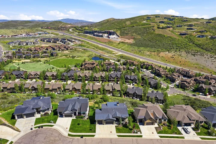 Expansive residential development featuring varied architectural styles and mature landscaping within a mountainous setting