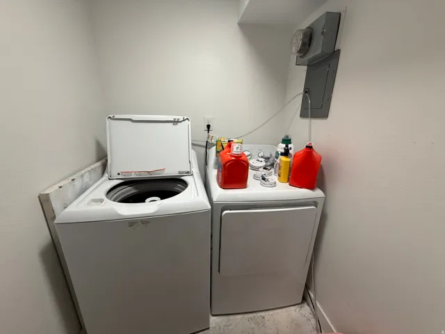 Dedicated laundry area featuring a top-load washing machine and a front-load dryer