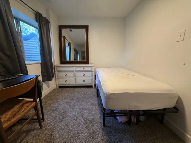 Carpeted room with a window, white walls, and white trim