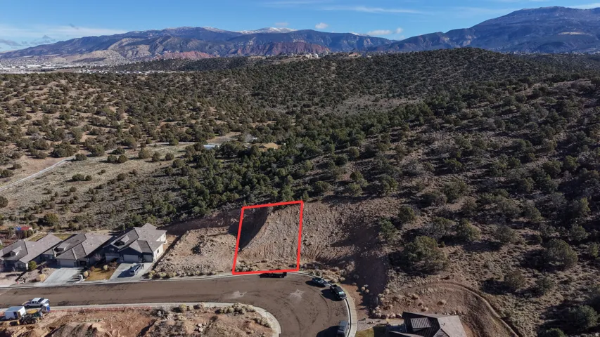 Expansive undeveloped lot featuring natural desert landscaping and distant mountain scenery