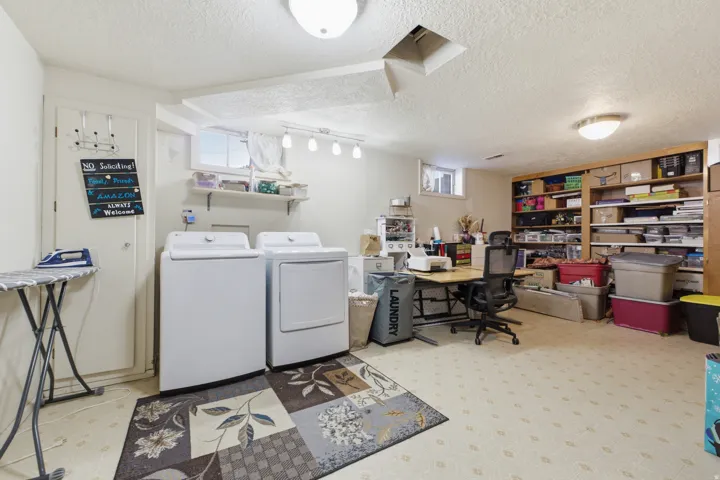 Dedicated laundry area featuring a washer and dryer setup