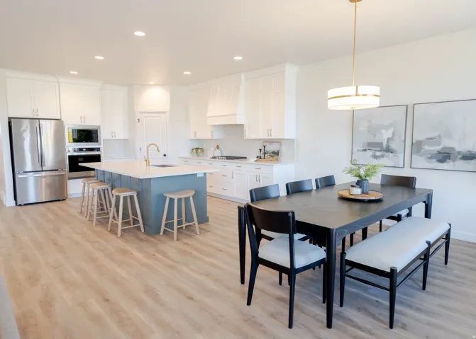Open-concept kitchen and dining area featuring light wood-finish flooring