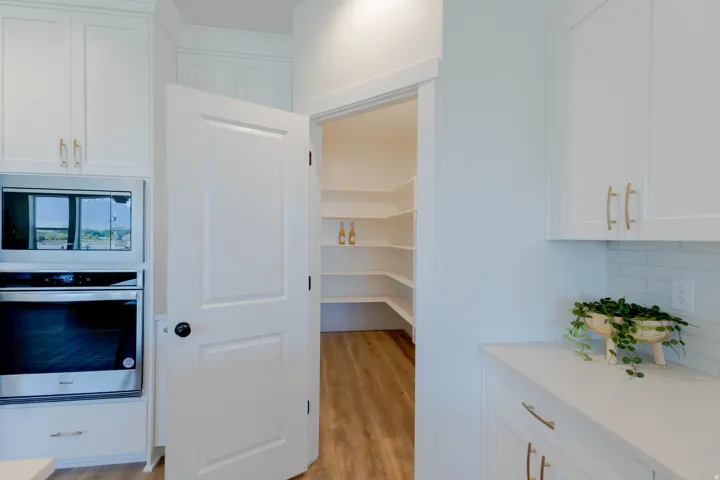 Expansive walk-in pantry with multiple built-in shelving units