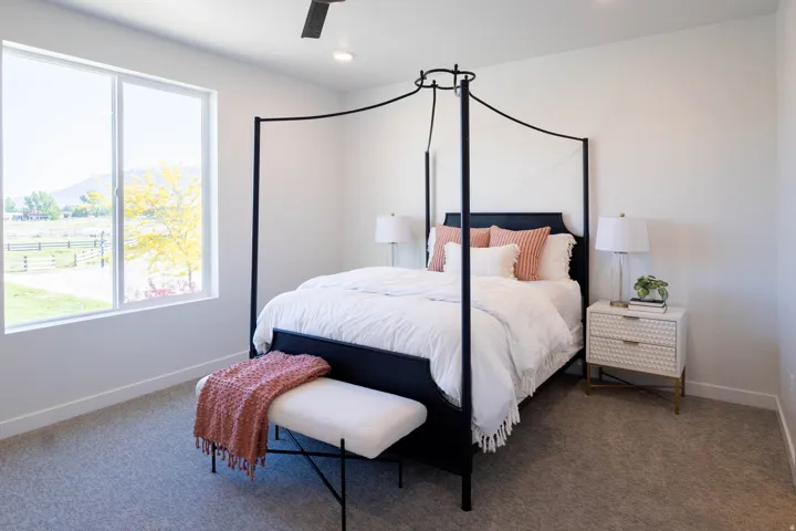 Spacious room with large windows, recessed lighting, and a ceiling fan