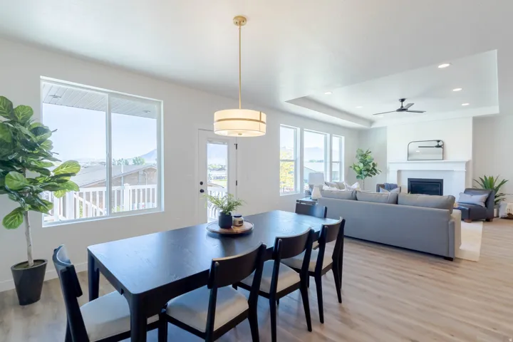 Open-concept living space featuring wood-finish flooring and multiple windows