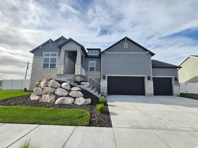 Modern home exterior featuring stone and siding finishes