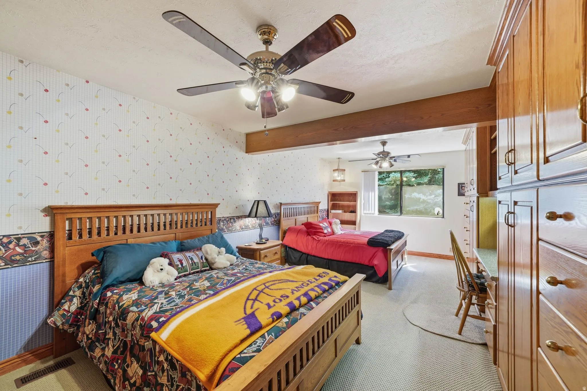 Bright interior featuring exposed ceiling beam, recessed lighting, and dual ceiling fans