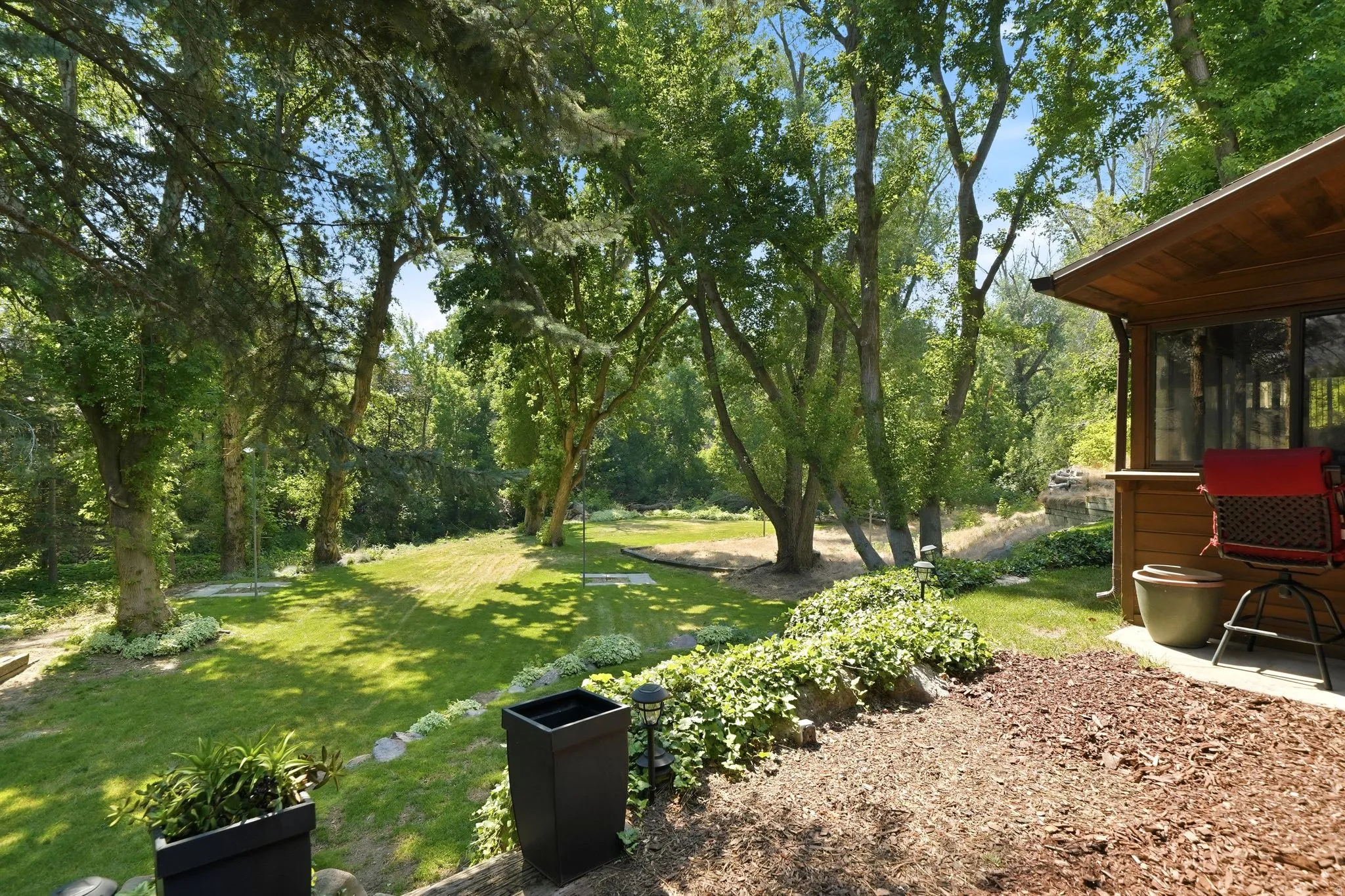 Wood-sided property with an outdoor patio area