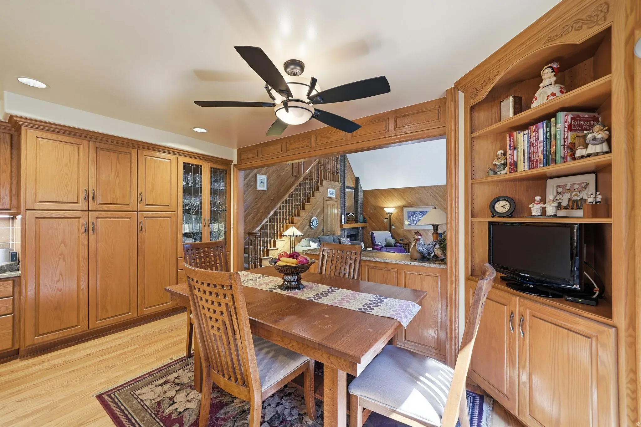 Dining area featuring built-in cabinetry, wood-finish flooring, recessed lighting, and a ceiling fan