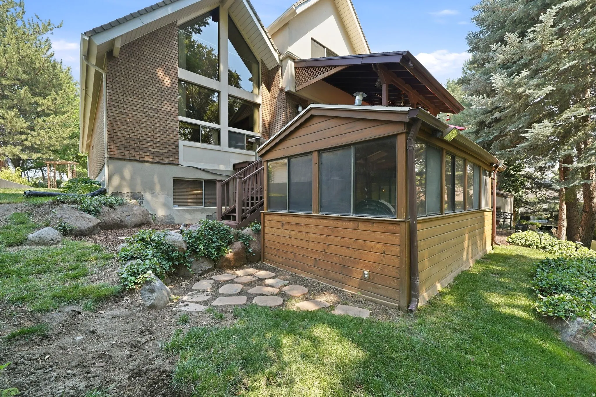 Screened enclosure with wood-finish siding
