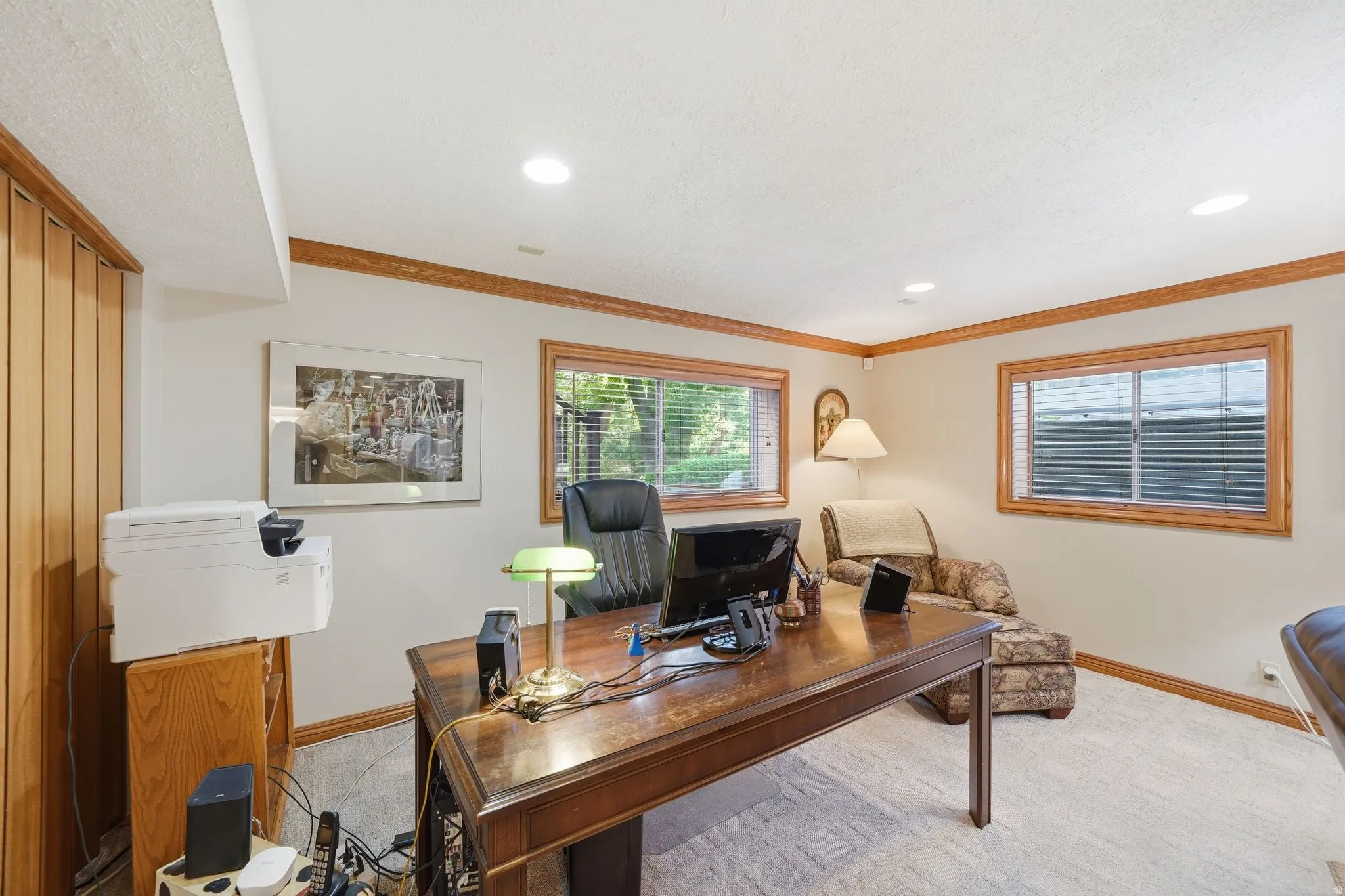 Bright room featuring wood-trim windows, recessed lighting, and soft carpeting