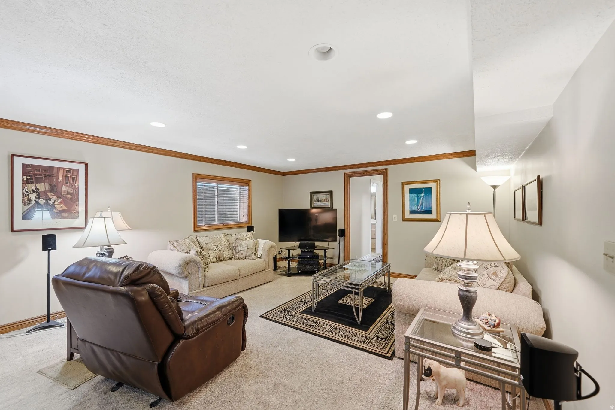 Spacious recreation room featuring recessed lighting, a window with blinds, and wood-finish trimwork
