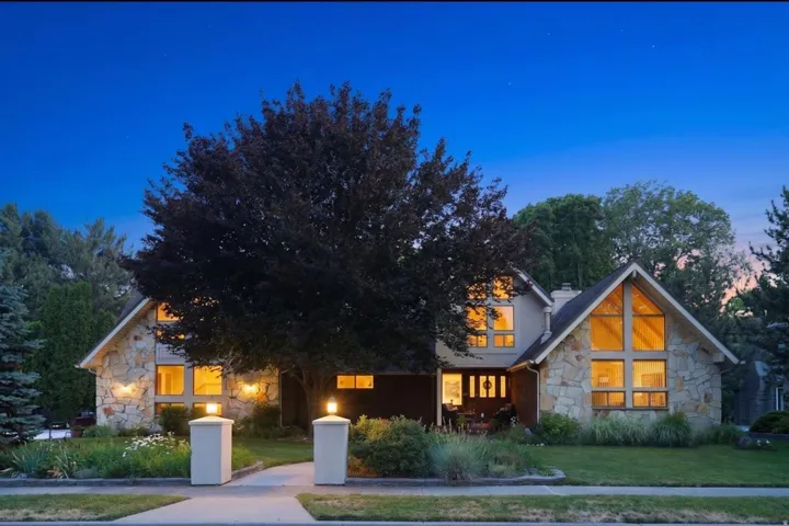 Stone veneer exterior with a prominent A-frame window design