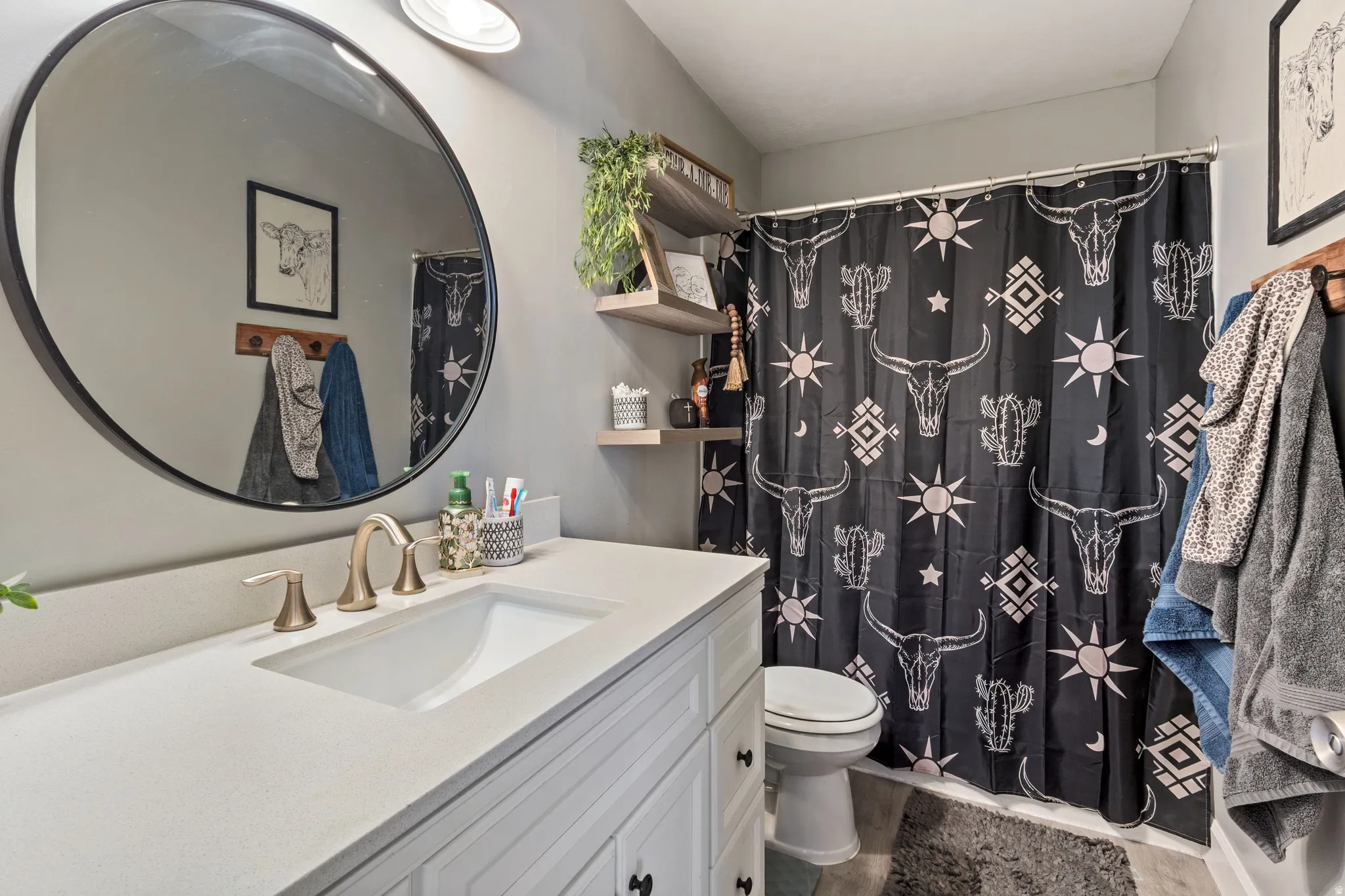 Bathroom vanity featuring a light-colored countertop with an integrated sink and brushed nickel faucet