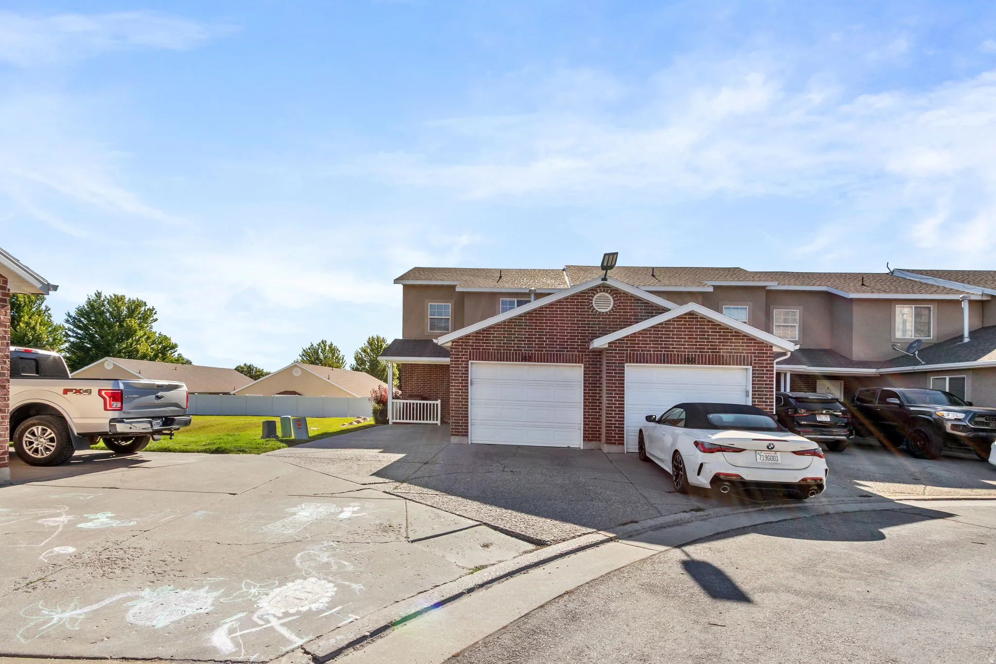 Brick exterior townhome with two attached garage bays