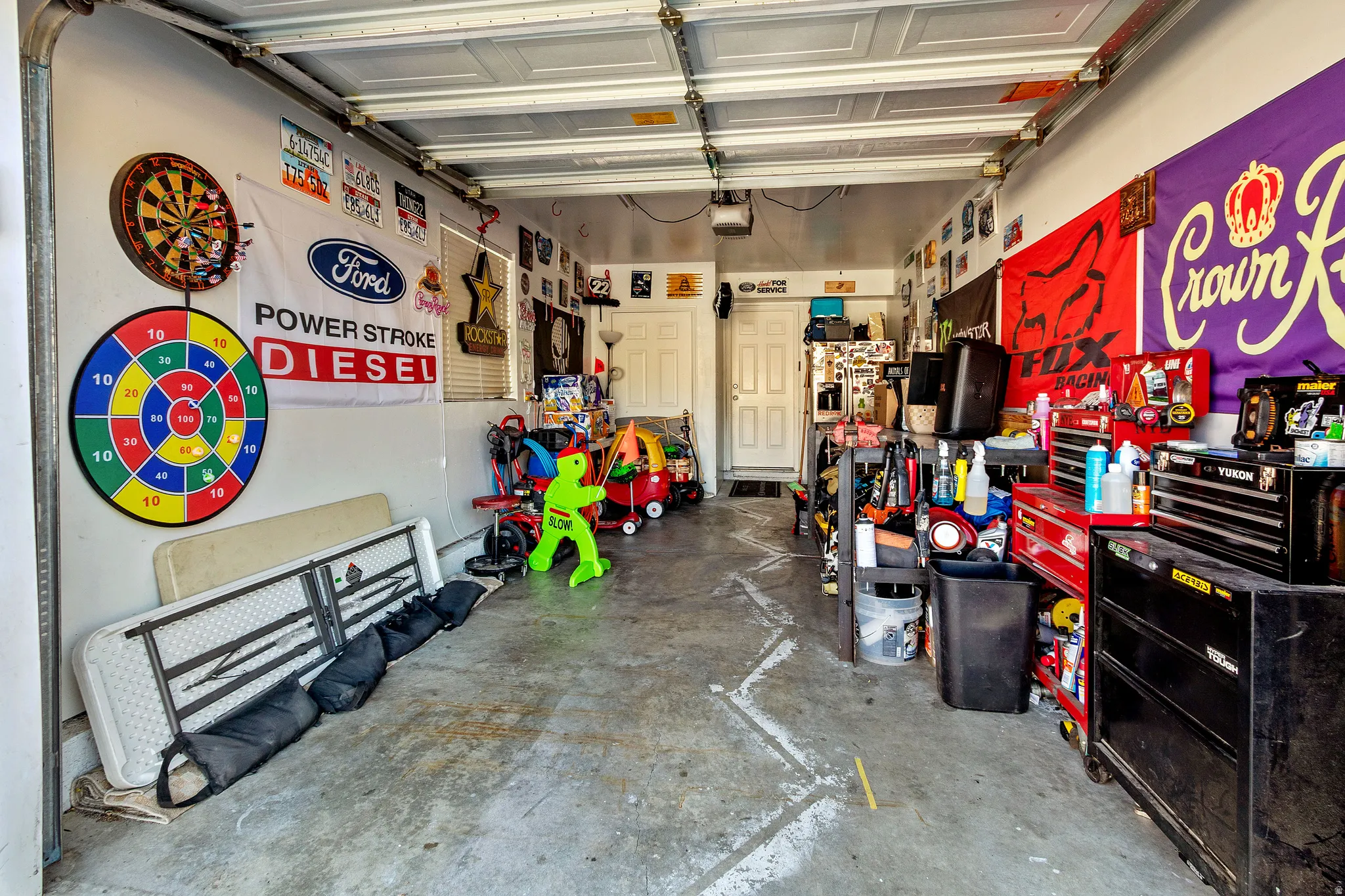Single-car garage with a concrete floor and white walls