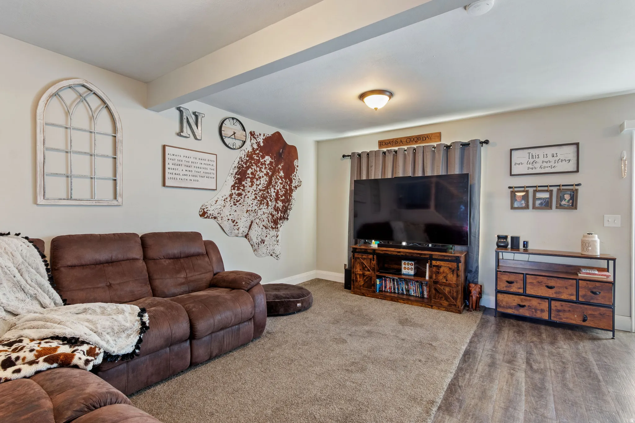 Spacious interior featuring a combination of soft carpet and wood-finish flooring