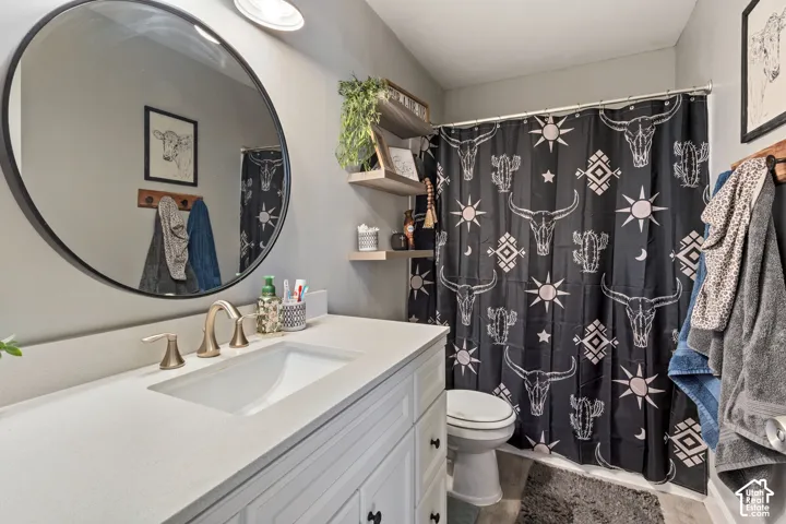 Bathroom vanity featuring a light-colored countertop with an integrated sink and brushed nickel faucet
