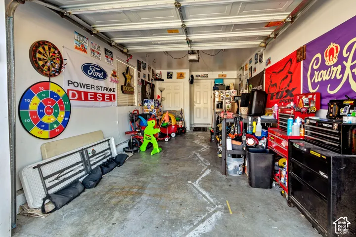 Single-car garage with a concrete floor and white walls