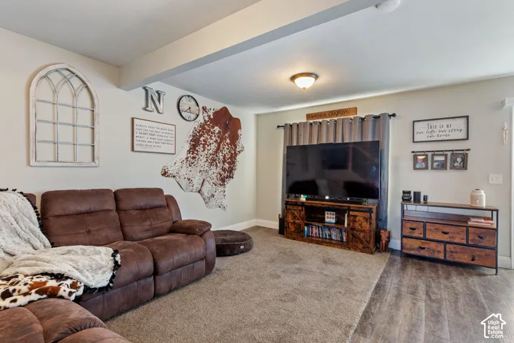 Spacious interior featuring a combination of soft carpet and wood-finish flooring