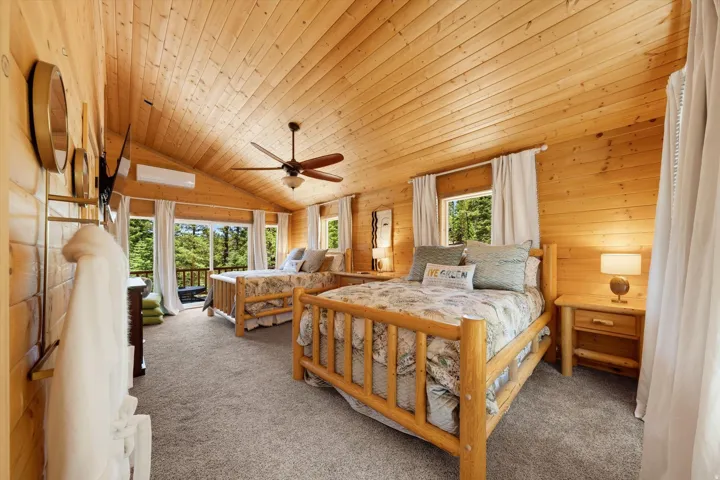 Vaulted wood-paneled ceilings over gray carpeting