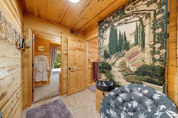 Wood-paneled interior featuring a recessed ceiling light and planked ceiling