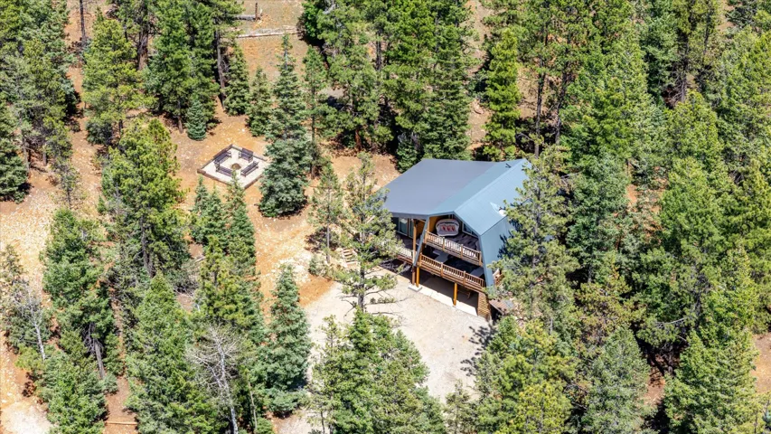 Contemporary-style home featuring a metal roof, an upper-level balcony, and a lower-level deck