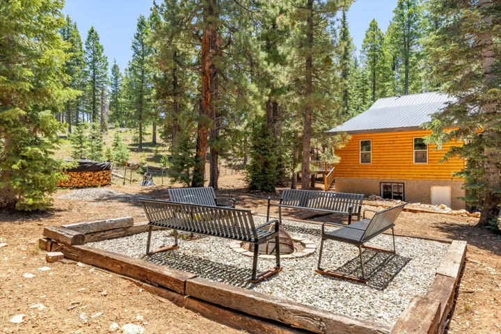 Outdoor seating area featuring a built-in fire pit with a gravel surround