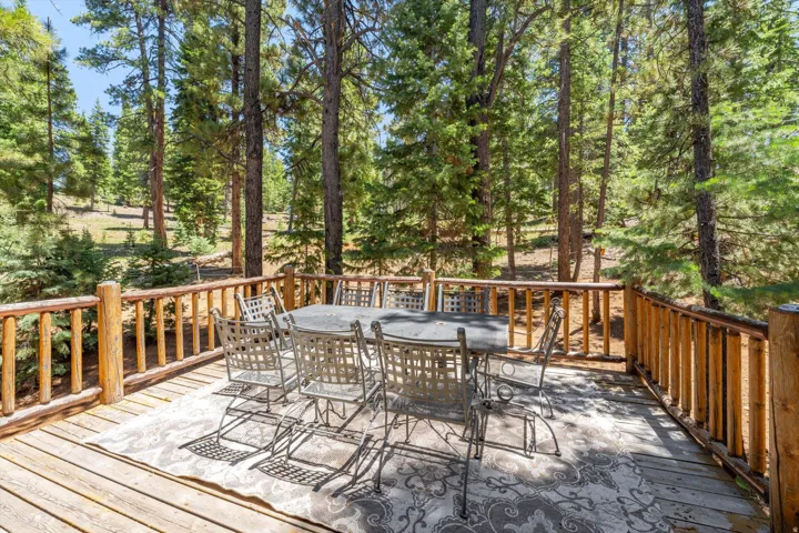 Outdoor deck featuring natural wood railing and decking