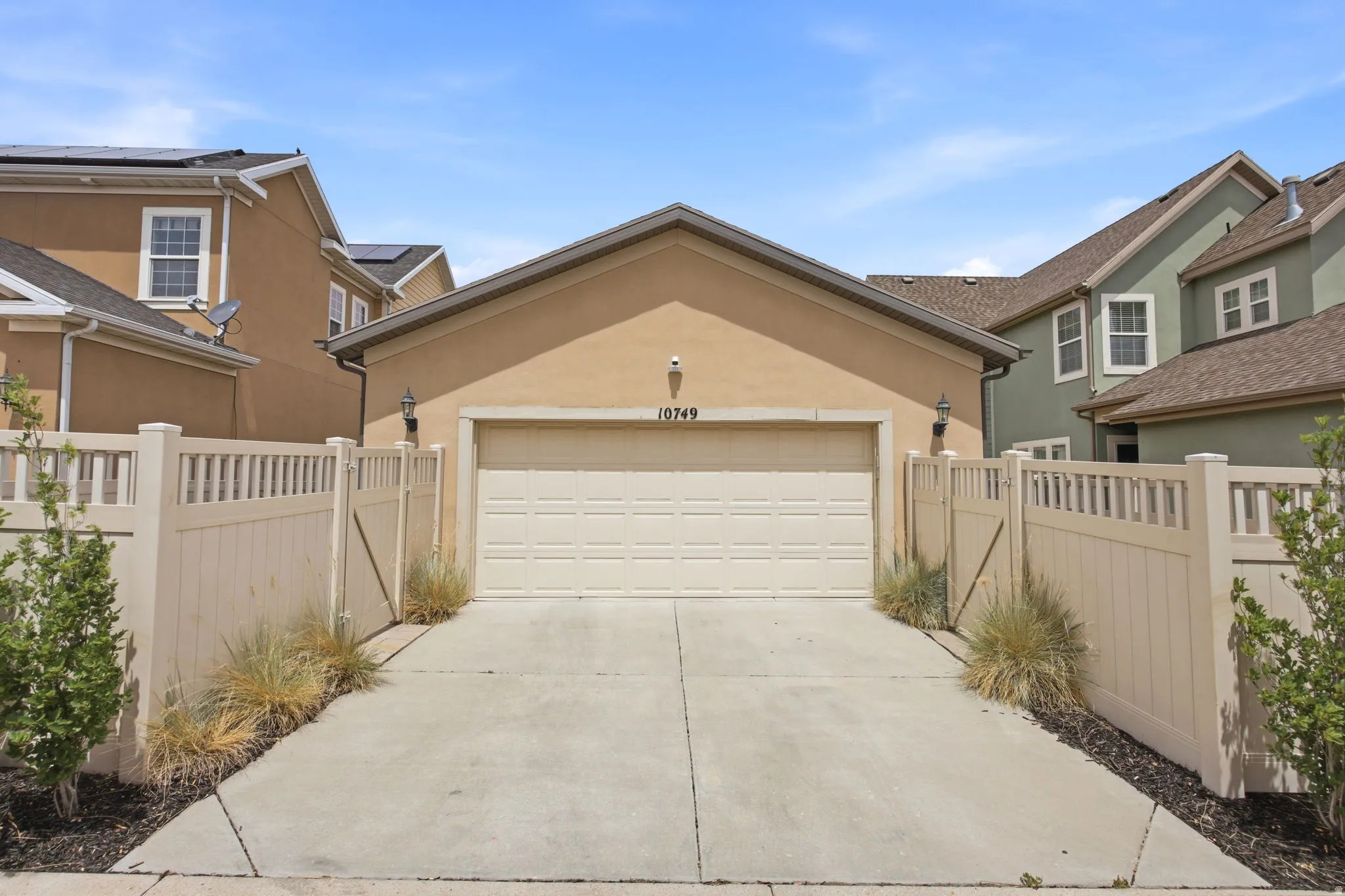 Attached two-car garage with a light-colored door and stucco exterior