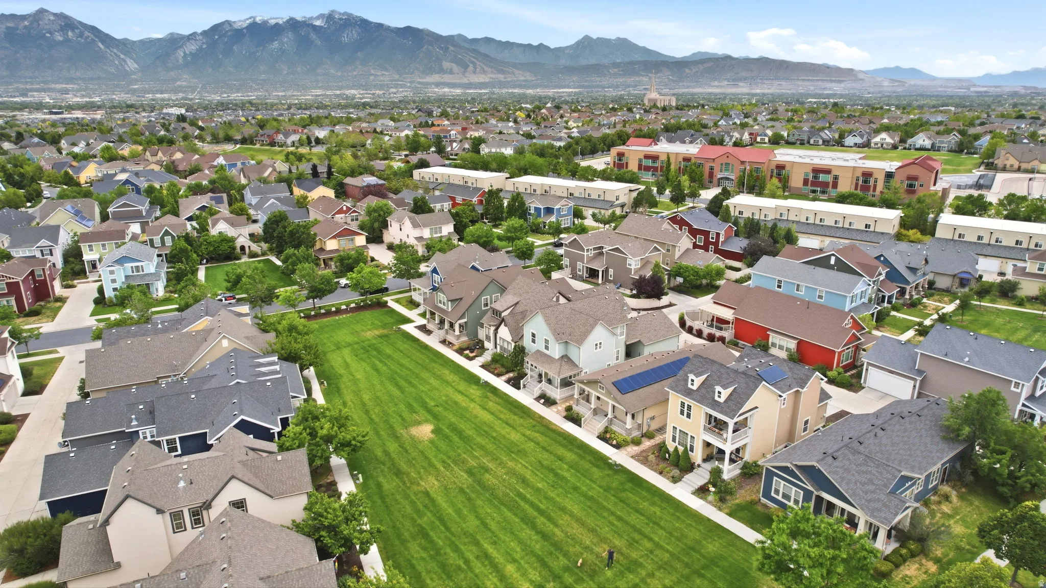 Expansive residential community featuring diverse architectural styles and a large central green space