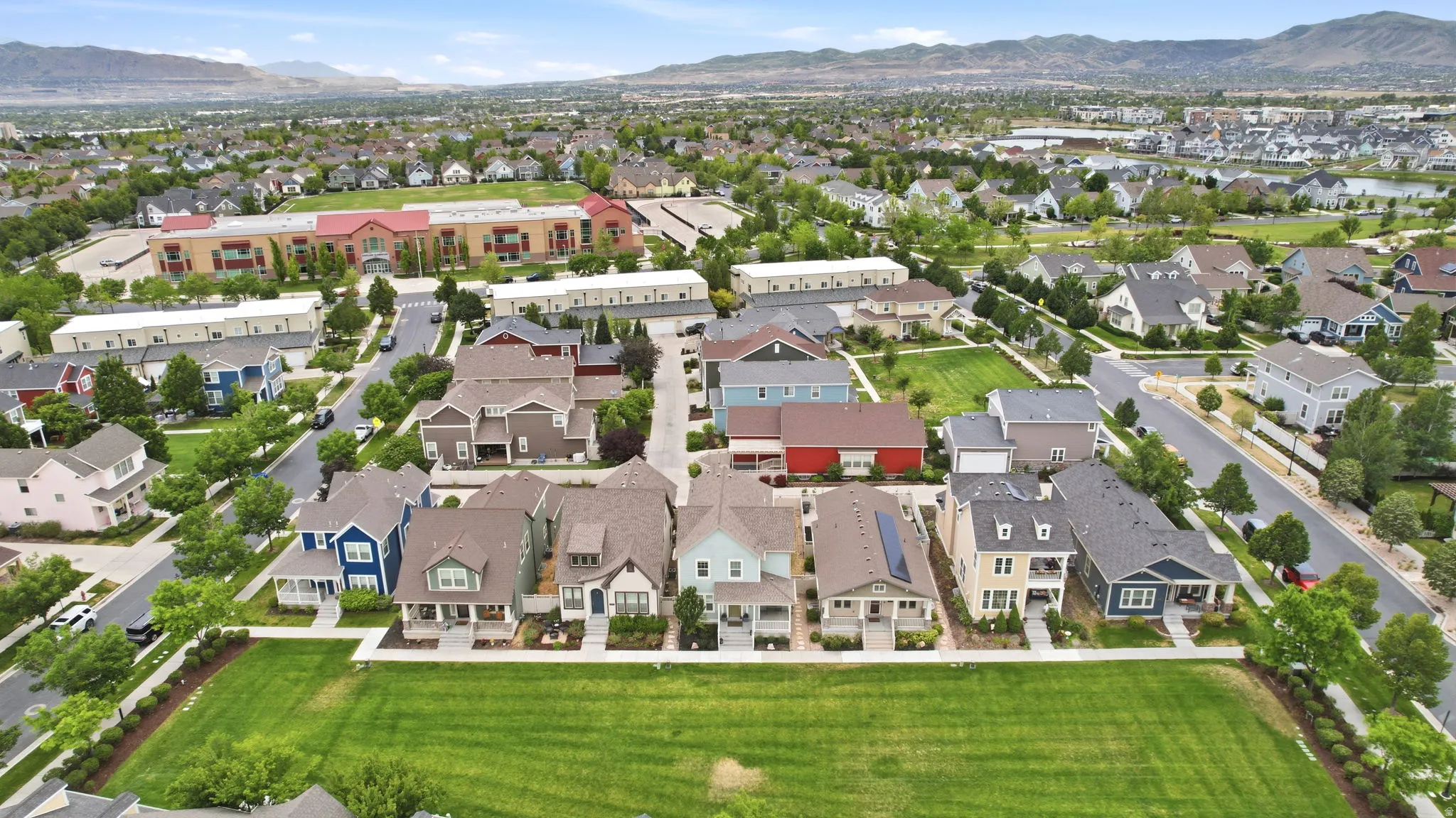 Residential neighborhood featuring a variety of architectural styles, green spaces, and mountain backdrops