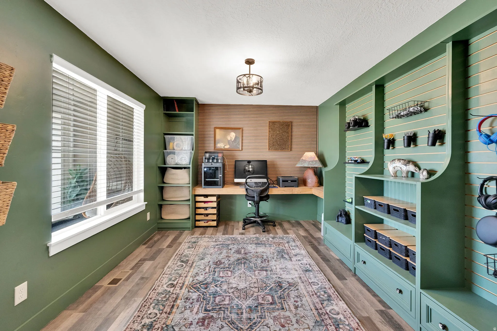 Interior space featuring wood-finish flooring and a built-in desk with shelving