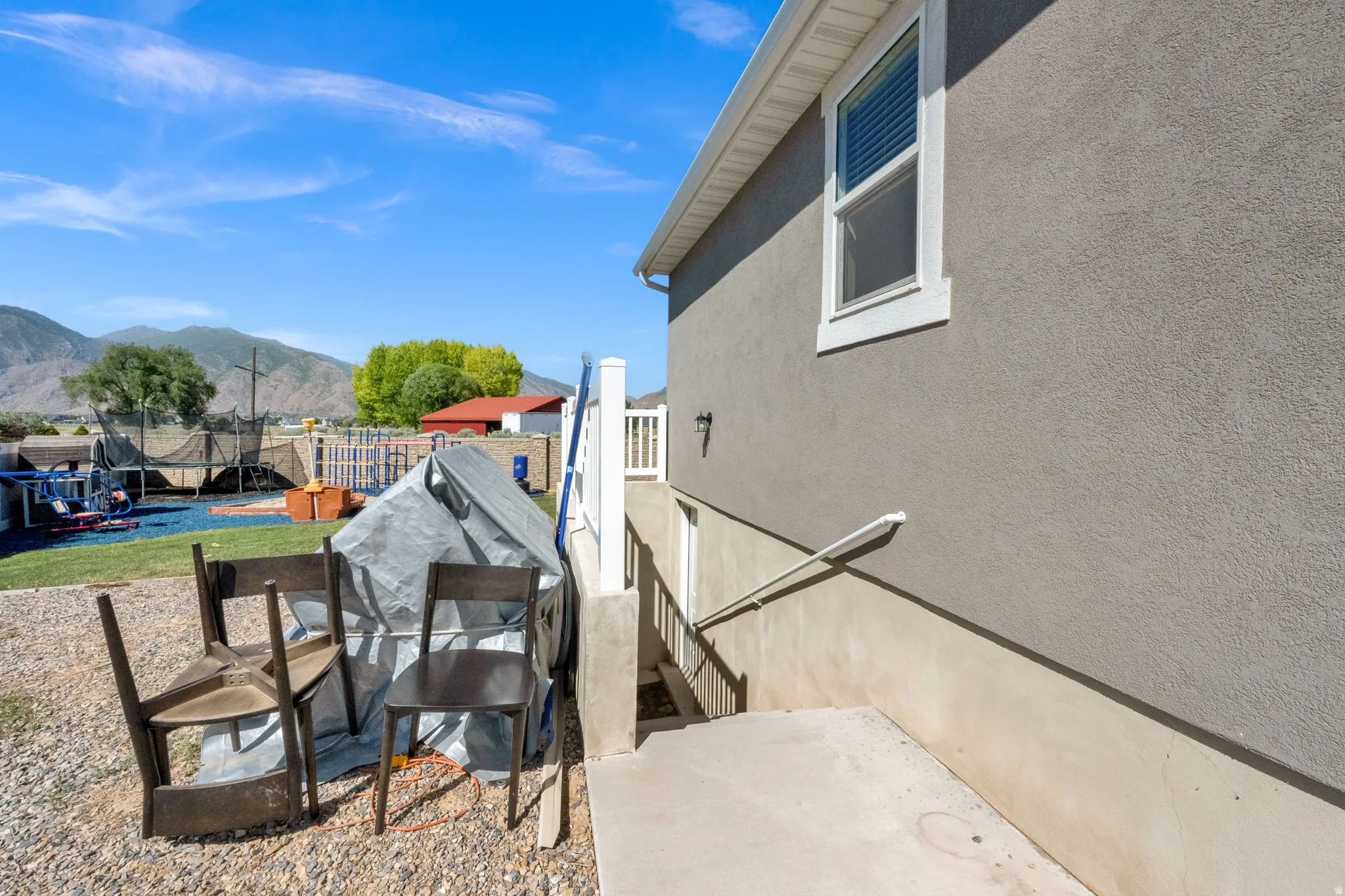 Exterior stucco finish with a window featuring white trim