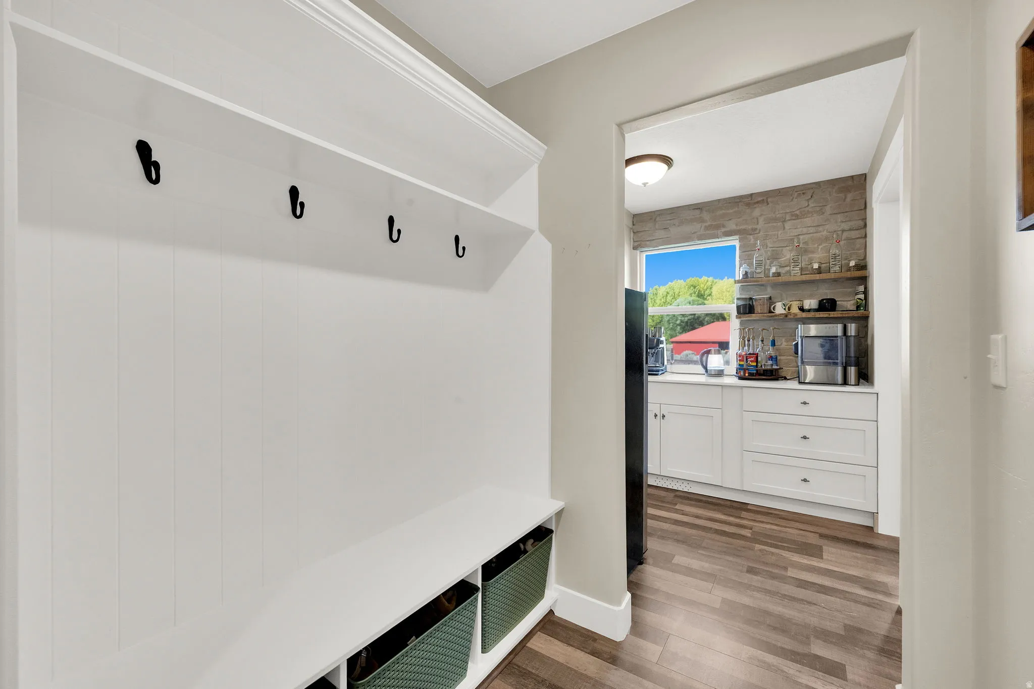 Built-in hall tree with upper shelf, five coat hooks, and bench seating
