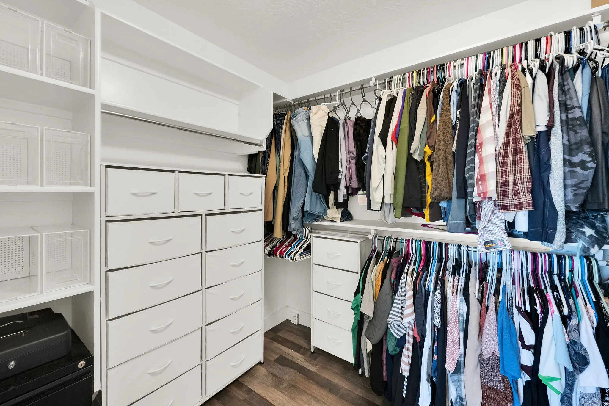 Custom closet system featuring built-in shelving, multiple hanging rods, and integrated drawer units