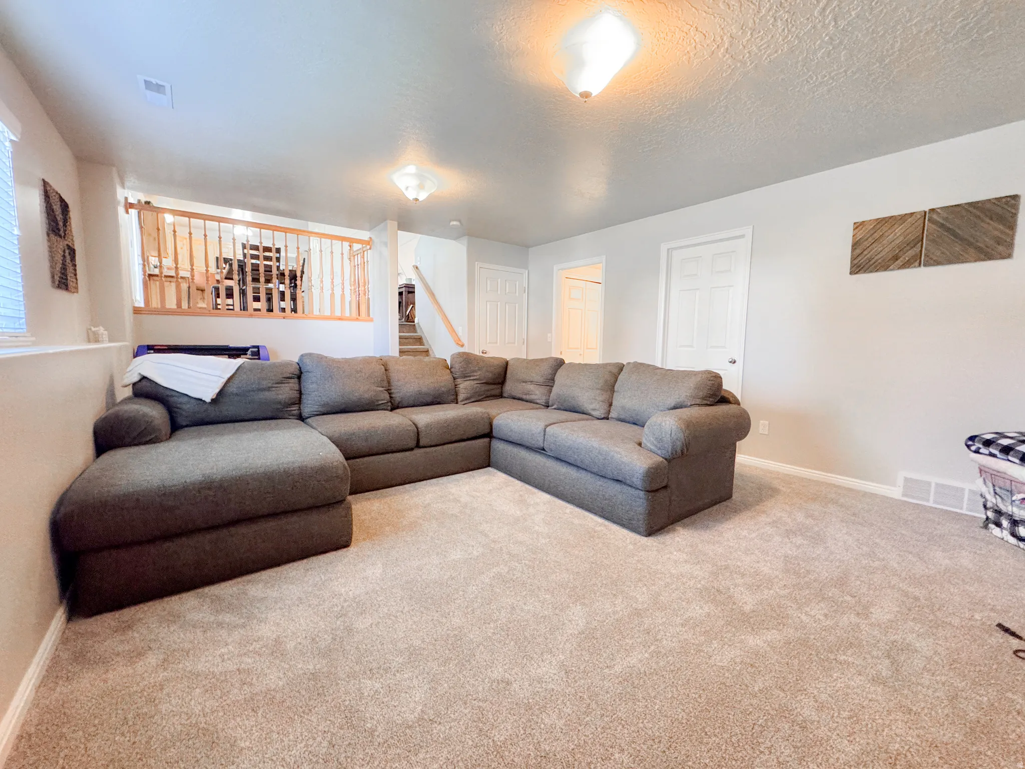 Carpeted recreation area featuring light wall paint, white trim, and recessed lighting