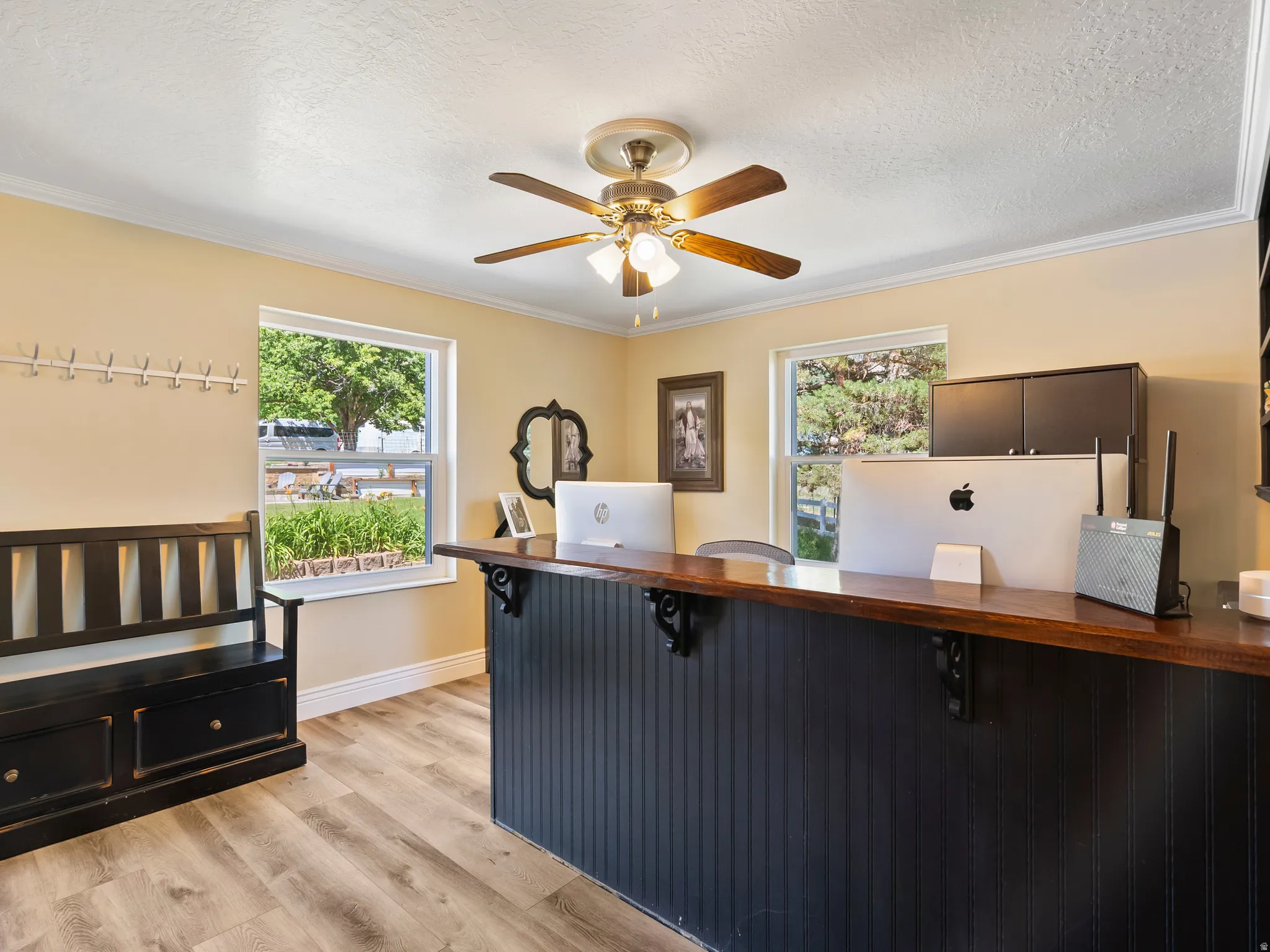 Spacious room featuring wood-finish flooring and multiple windows
